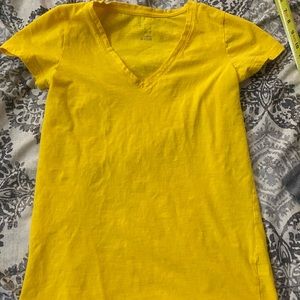 Yellow v neck t shirt.